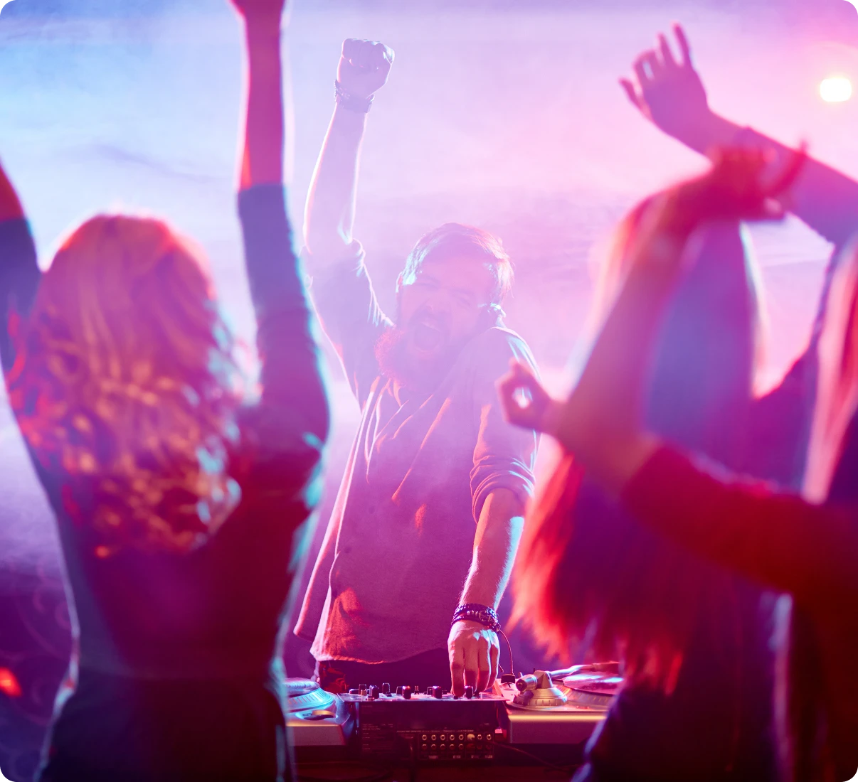 Excited crowd dancing with DJ